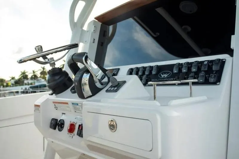 Slide: The Image of 2026 Southport 30 FE boat dashboard with steering wheel and control panel. - 2