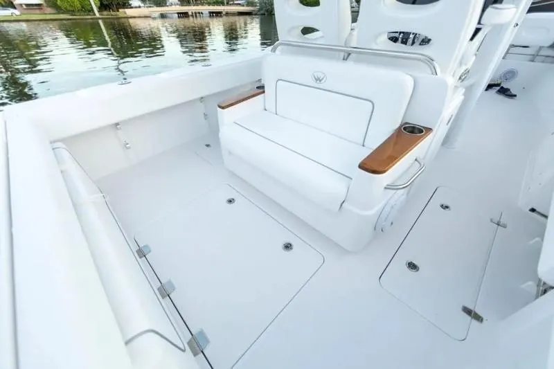 Slide: The Image of 2026 Southport 30 FE boat interior with white seating and wooden armrests. - 4