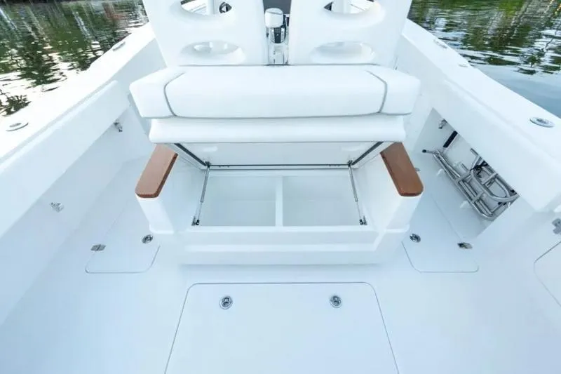 Slide: The Image of 2026 Southport 30 FE boat interior with white seating and storage compartments. - 5