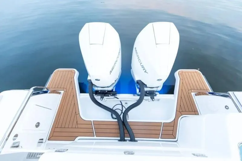 Slide: The Image of 2026 Southport 30 FE boat with dual Mercury outboard engines on teak deck. - 6