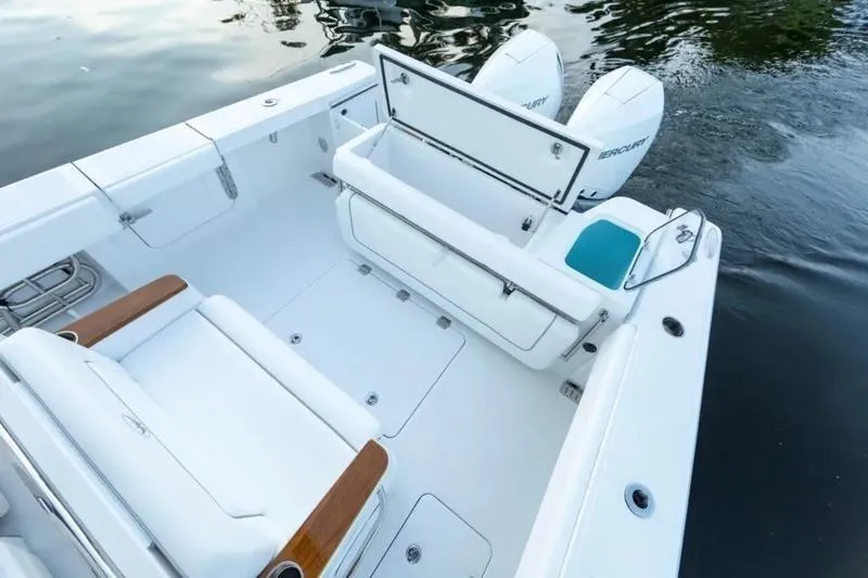Slide: The Image of 2026 Southport 30 FE boat deck with seating and storage, featuring twin outboard engines. - 7