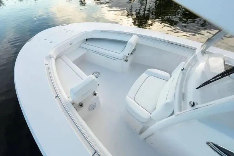 Slide: The Image of 2026 Southport 30 FE boat interior with white seating and sleek design on calm water. - 8