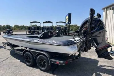 Slide: The Image of 2026 Skeeter ZXE20 boat with dual motors on a trailer in a parking lot. - 2