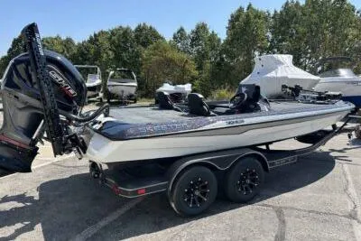 Slide: The Image of 2026 Skeeter ZXE20 boat with dual axle trailer, parked outdoors. - 3