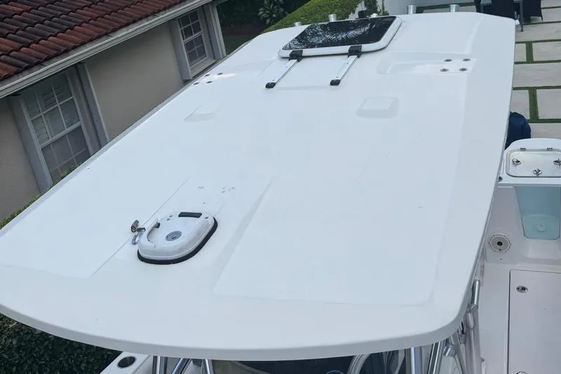 Slide: The Image of 2021 Sea Fox 268 Commander boat roof with hatch, docked near a house. - 13