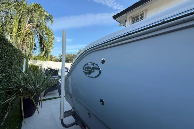 Slide: The Image of 2021 Sea Fox 268 Commander boat parked near tropical plants and a house. - 19