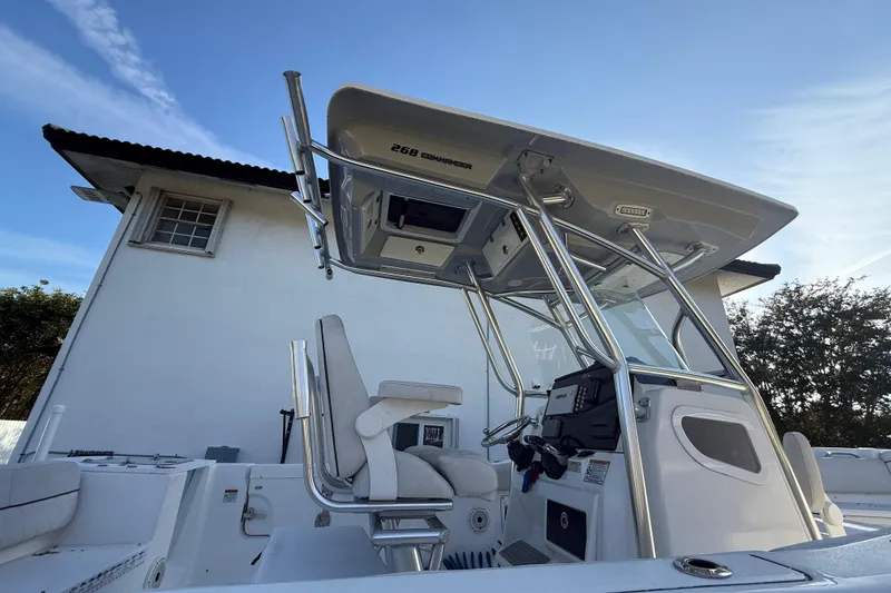 Slide: The Image of 2021 Sea Fox 268 Commander boat with T-top and helm, parked near a building. - 20