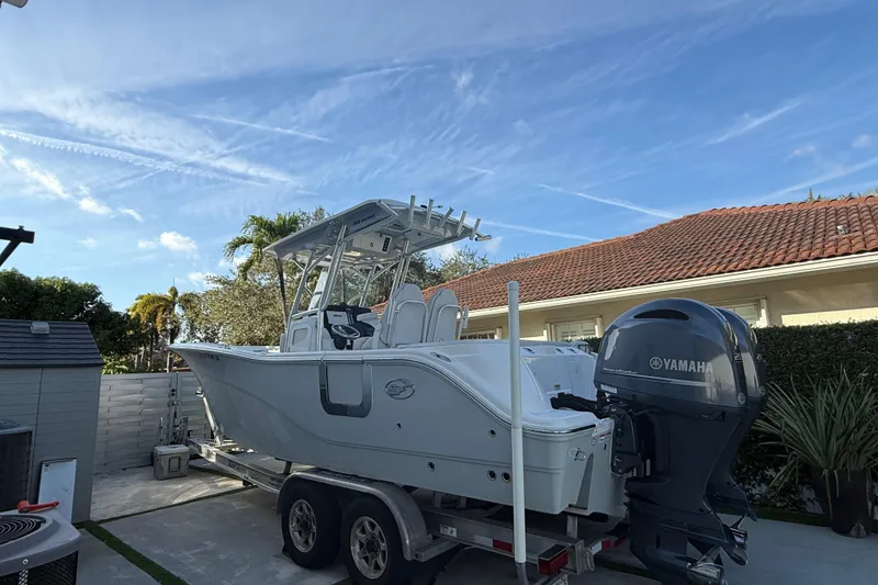Slide: The Image of 2021 Sea Fox 268 Commander boat on trailer with Yamaha outboard motor, parked outdoors. - 22