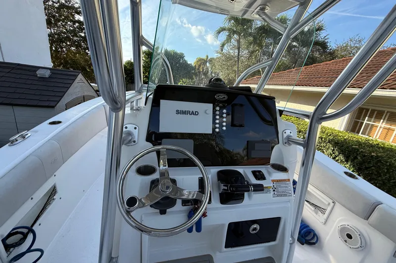Slide: The Image of 2021 Sea Fox 268 Commander boat dashboard with Simrad display and steering wheel. - 31