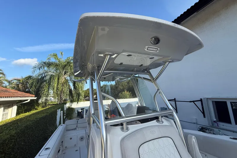 Slide: The Image of 2021 Sea Fox 268 Commander boat with T-top and seating, parked outdoors. - 47