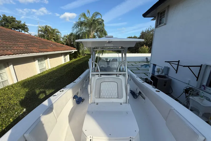 Slide: The Image of 2021 Sea Fox 268 Commander boat docked near residential area, surrounded by greenery. - 50