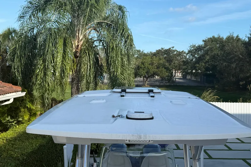 Slide: The Image of 2021 Sea Fox 268 Commander boat top with lush greenery background. - 51