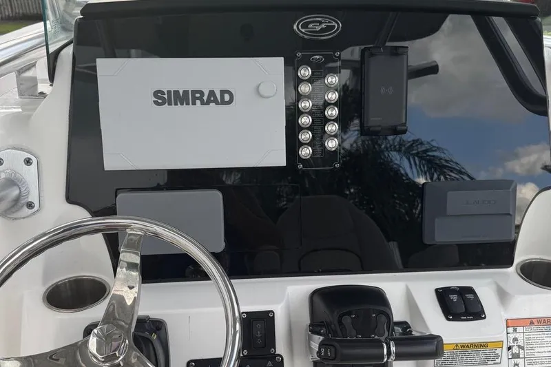 Slide: The Image of 2021 Sea Fox 268 Commander dashboard with Simrad electronics and steering wheel. - 6