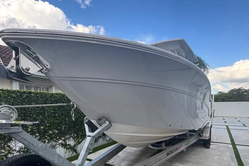 Slide: The Image of 2021 Sea Fox 268 Commander boat on trailer, parked outdoors under blue sky. - 64