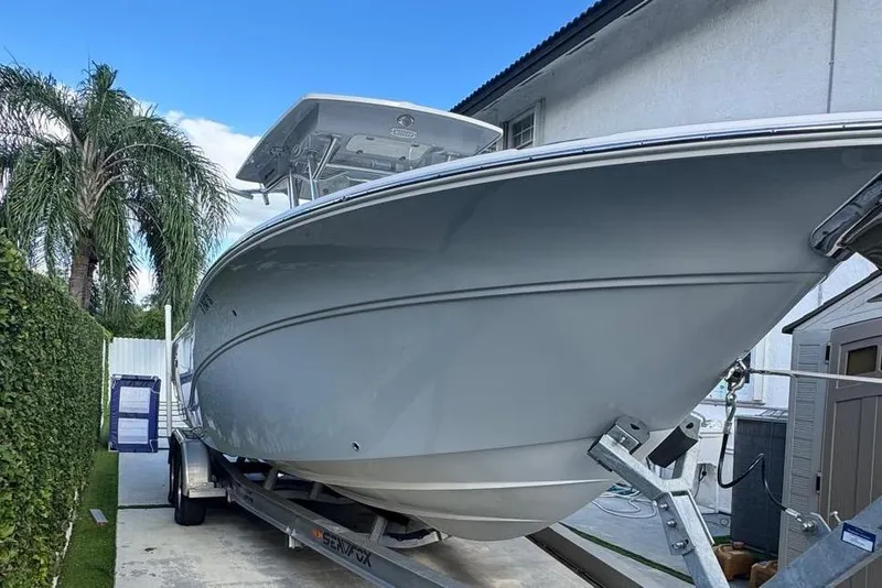 Slide: The Image of 2021 Sea Fox 268 Commander boat on trailer, parked beside a house and palm tree. - 65