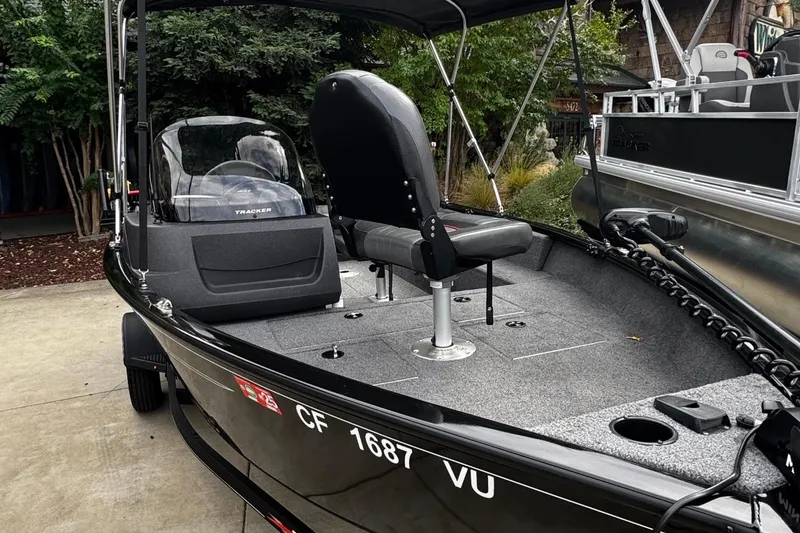 Slide: The Image of 2021 Tracker Pro Guide V-16 SC boat with seating and control console. - 2