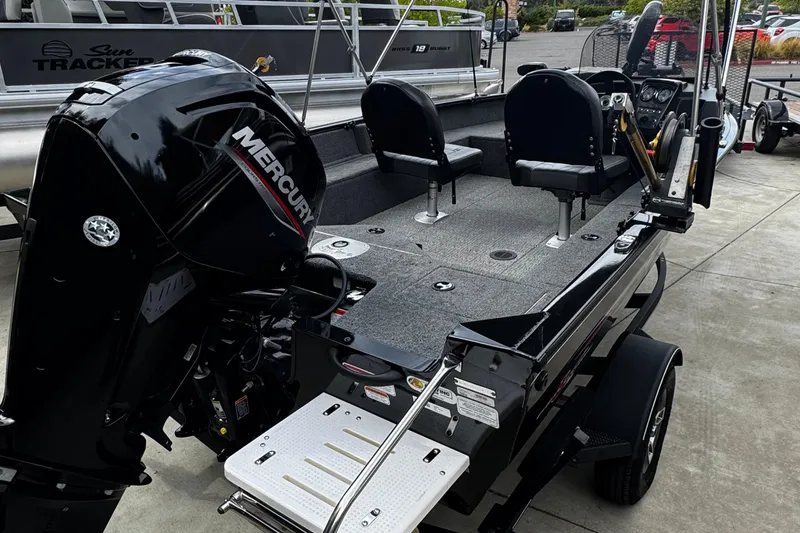 Slide: The Image of 2021 Tracker Pro Guide V-16 SC boat with Mercury engine, docked on trailer. - 3