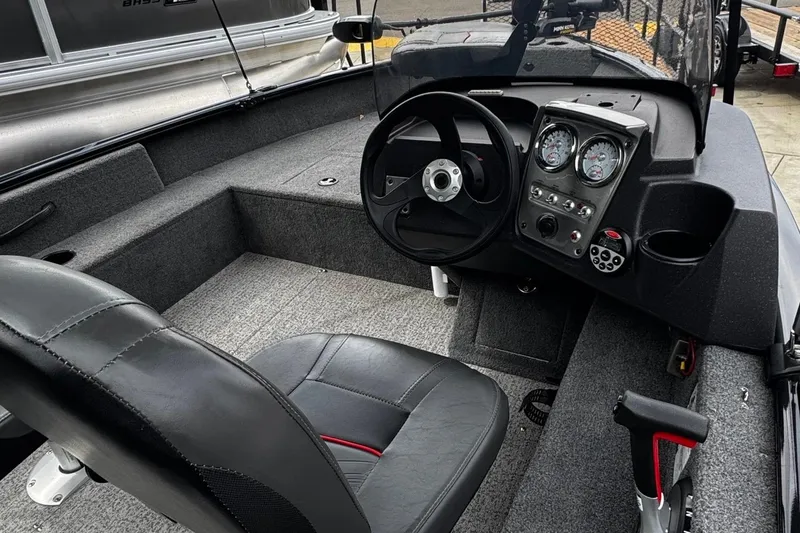 Slide: The Image of 2021 Tracker Pro Guide V-16 SC boat interior with steering wheel and dashboard controls. - 4