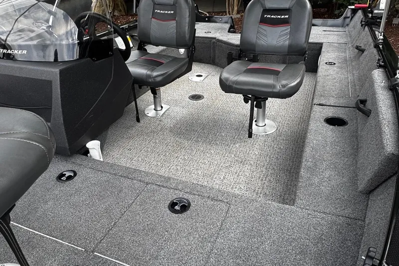 Slide: The Image of 2021 Tracker Pro Guide V-16 SC boat interior with seating and carpeted floor. - 5