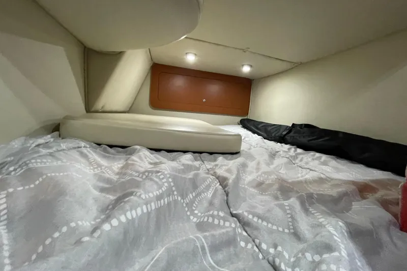 Slide: The Image of Cozy cabin interior of 2005 Chaparral 270 Signature boat with bedding and soft lighting. - 10