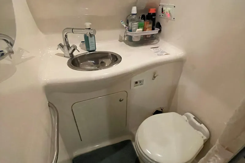 Slide: The Image of Compact bathroom in 2005 Chaparral 270 Signature boat with sink and toilet. - 12