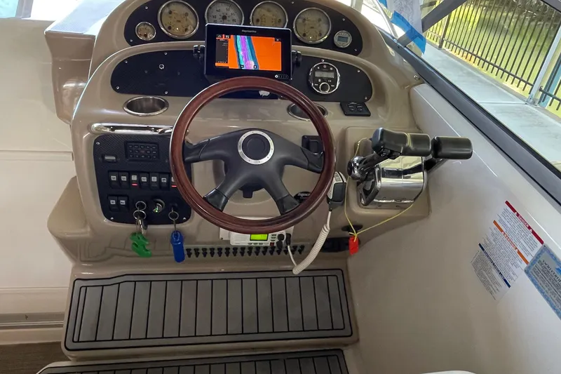 Slide: The Image of 2005 Chaparral 270 Signature boat dashboard with steering wheel and control panel. - 13