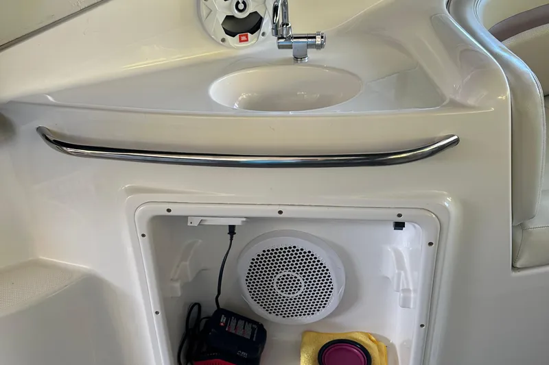 Slide: The Image of 2005 Chaparral 270 Signature boat interior with sink, speaker, and storage compartment. - 15