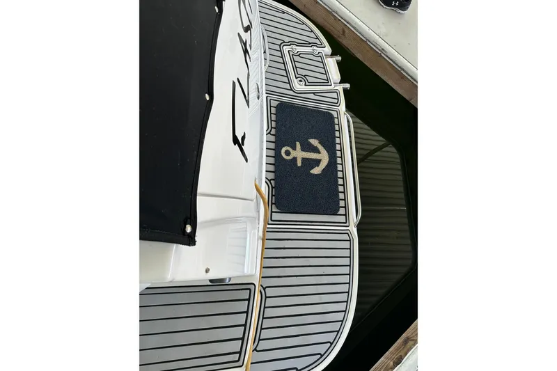 Slide: The Image of 2005 Chaparral 270 Signature boat with anchor-themed mat on deck. - 17