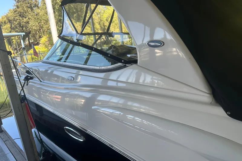 Slide: The Image of 2005 Chaparral 270 Signature boat docked, featuring sleek white and black exterior. - 21