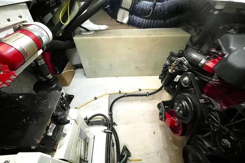 Slide: The Image of Engine compartment of 2005 Chaparral 270 Signature boat with visible fire extinguisher and mechanical components. - 25