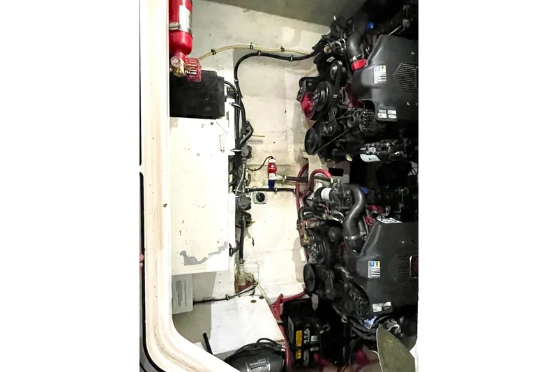 Slide: The Image of Engine compartment of 2005 Chaparral 270 Signature boat with visible components and fire extinguisher. - 27