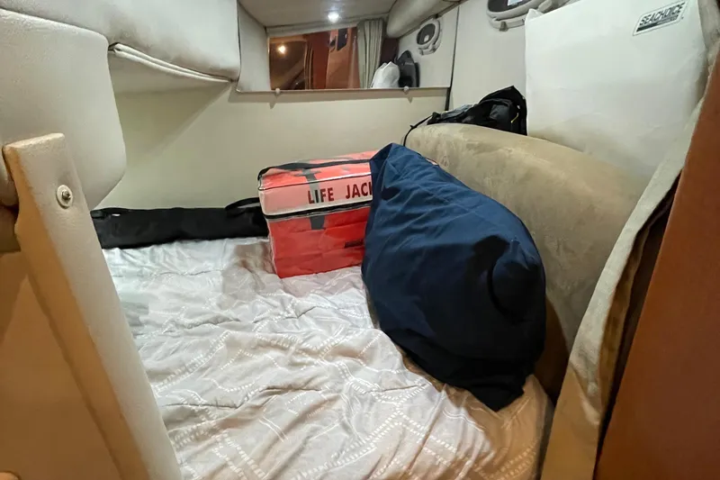 Slide: The Image of Cozy cabin interior of 2005 Chaparral 270 Signature with life jacket and bedding. - 3