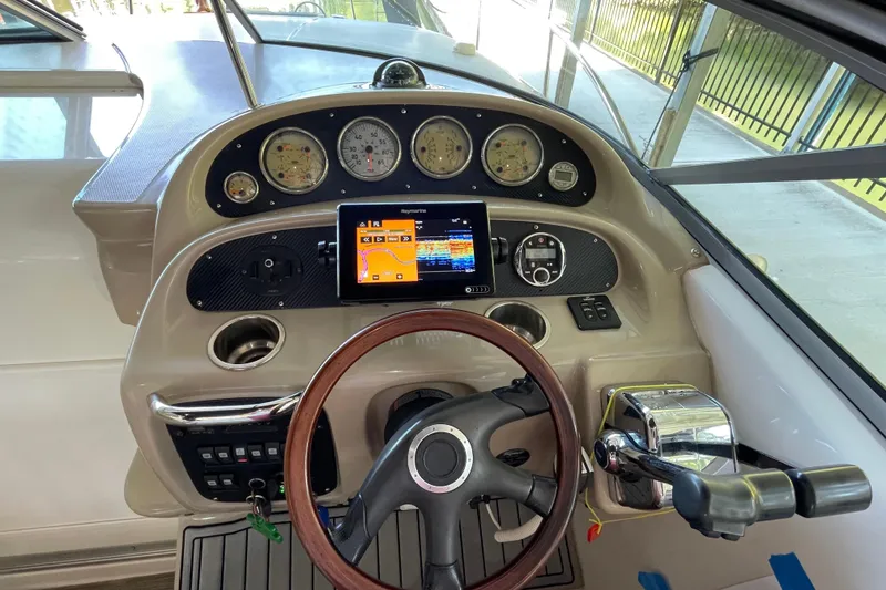 Slide: The Image of 2005 Chaparral 270 Signature boat dashboard with steering wheel and navigation system. - 4