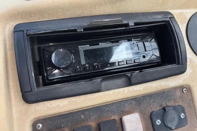 Slide: The Image of 1997 Grumman 24 FS dashboard with Boss Bluetooth stereo system. - 12