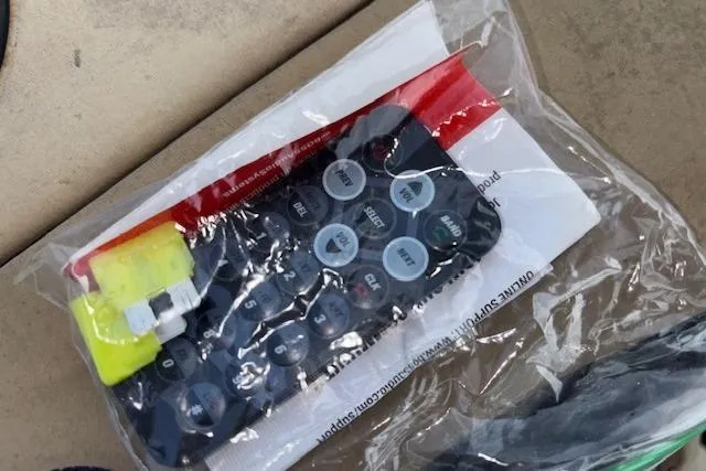 Slide: The Image of Remote control in plastic bag with documents, Grumman 24 FS, 1997 model. - 13