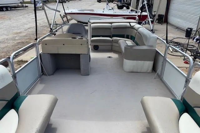 Slide: The Image of 1997 Grumman 24 FS pontoon boat interior with spacious seating and helm. - 17