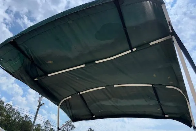 Slide: The Image of Bimini top of 1997 Grumman 24 FS boat against a cloudy sky. - 24