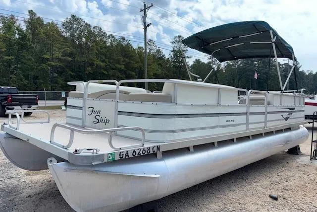 Slide: The Image of 1997 Grumman 24 FS pontoon boat with canopy, parked on gravel, labeled "Fun Ship." - 3