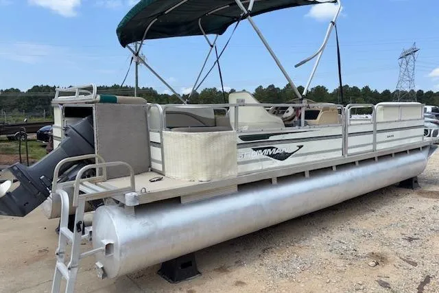 Slide: The Image of 1997 Grumman 24 FS pontoon boat with canopy, parked on land. - 7