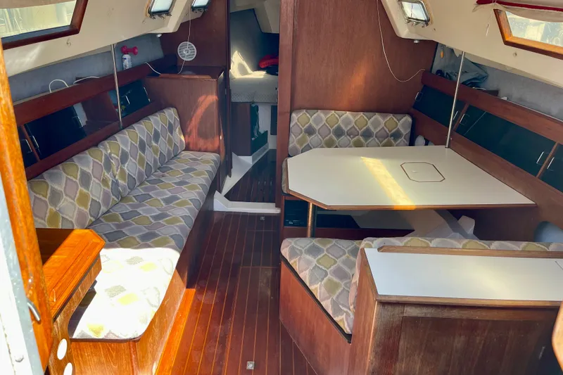 Slide: The Image of Interior of a 1985 Hunter 31 sailboat with wood finish and patterned seating. - 12