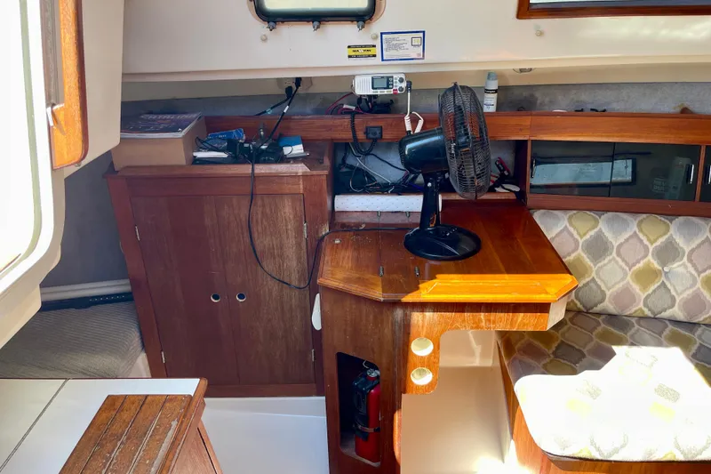 Slide: The Image of Interior of 1985 Hunter 31 sailboat with wooden cabinetry and seating area. - 19
