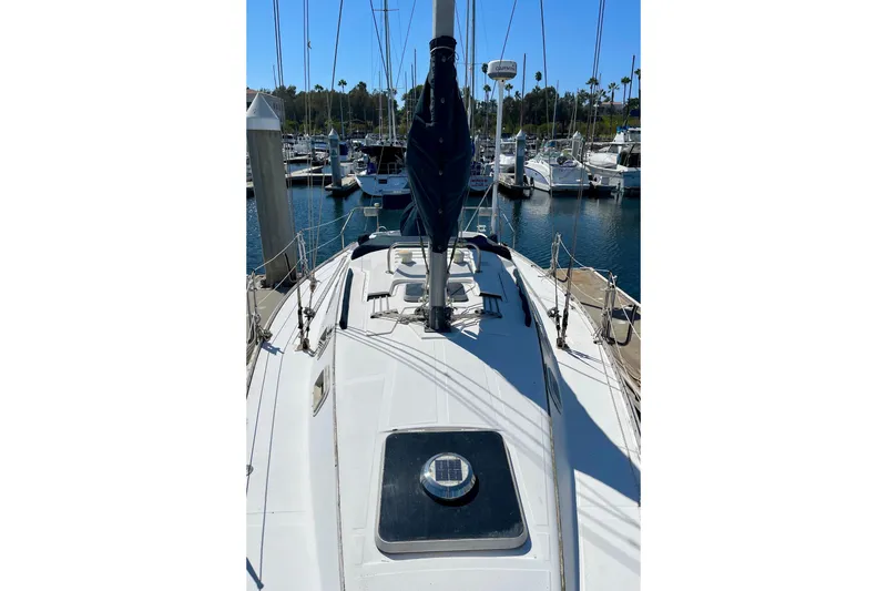 Slide: The Image of 1985 Hunter 31 sailboat docked at a marina, view of the deck and mast. - 2