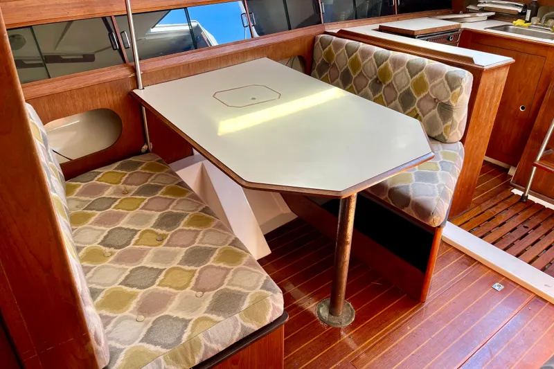 Slide: The Image of 1985 Hunter 31 sailboat interior with patterned seating and wooden accents. - 20