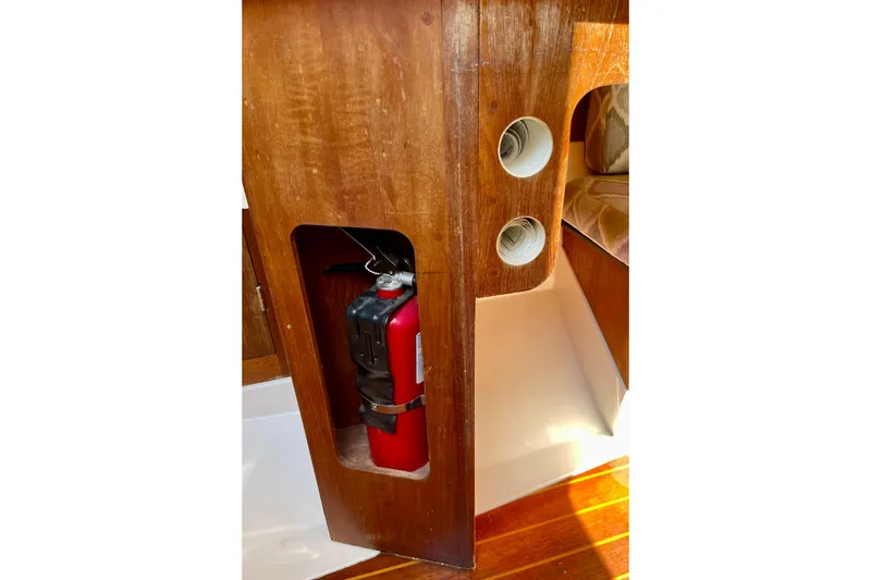Slide: The Image of 1985 Hunter 31 interior with fire extinguisher and wooden paneling. - 24