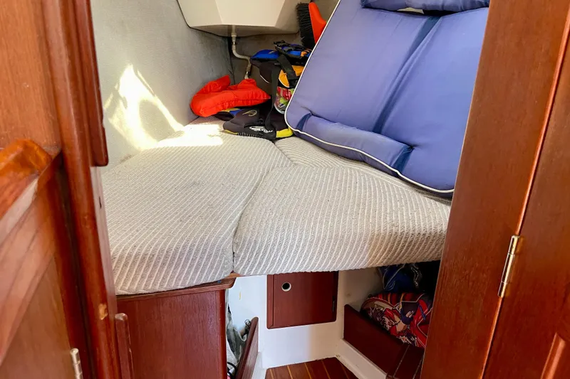 Slide: The Image of Interior cabin of a 1985 Hunter 31 sailboat with cushions and storage. - 27