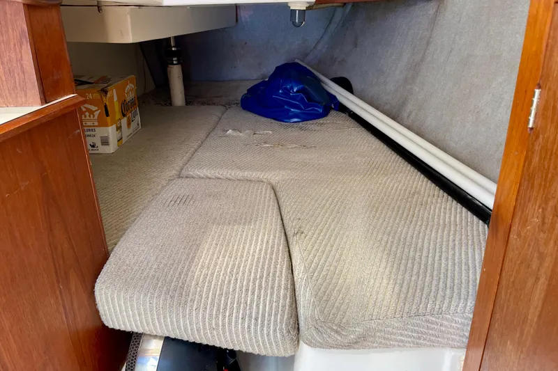 Slide: The Image of Interior cabin of 1985 Hunter 31 sailboat with carpeted seating and storage. - 28