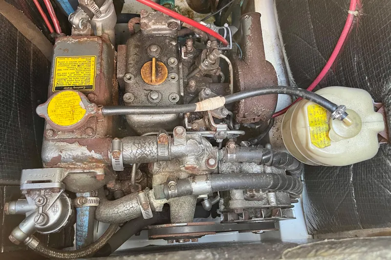 Slide: The Image of 1985 Hunter 31 engine compartment with visible components and wiring. - 31