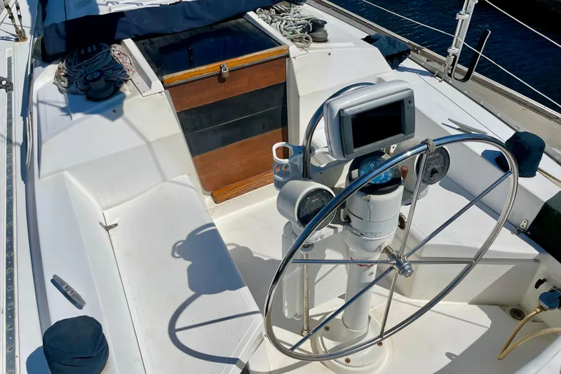Slide: The Image of 1985 Hunter 31 sailboat cockpit with steering wheel and navigation equipment. - 9