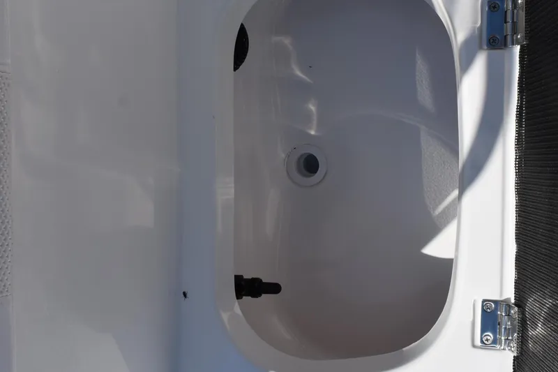 Slide: The Image of Open compartment of 2026 Frontier 180 boat, featuring a clean, white interior. - 14
