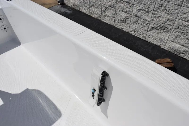 Slide: The Image of 2026 Frontier 180 boat interior with white textured surface and wall-mounted accessory. - 15